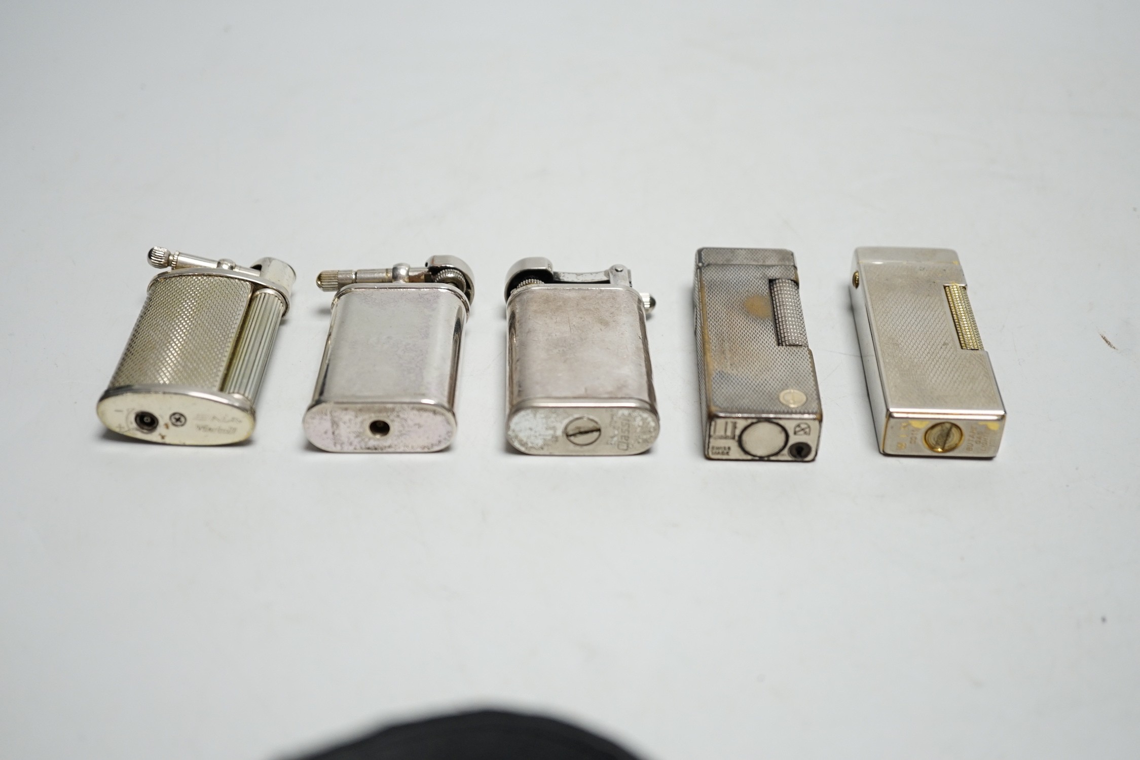 A Dunhill Rollegas lighter and four others